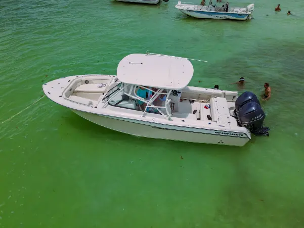 a boat gently floats on the crystal-clear water boat rental florida keys.